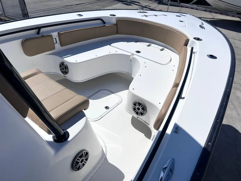 Slide: The Image of 2022 Cape Horn 24 XS boat interior with cushioned seating and built-in speakers. - 13