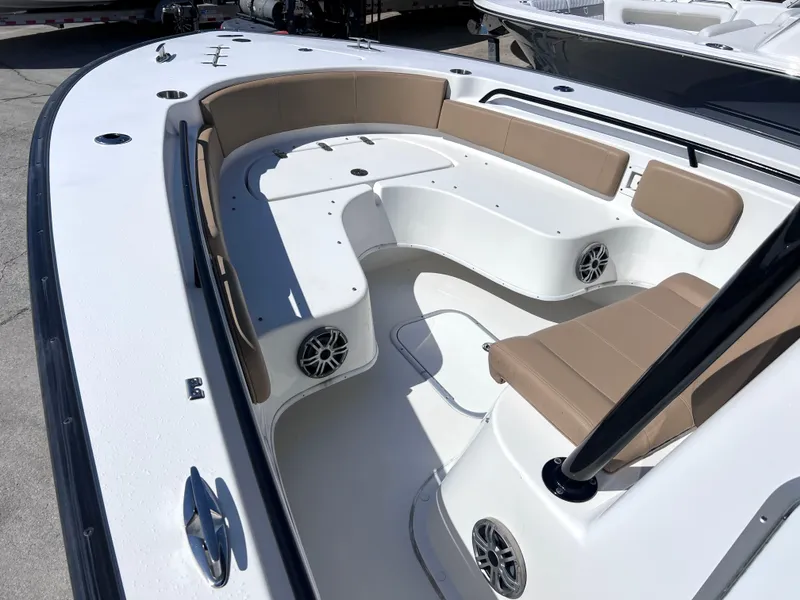 Slide: The Image of 2022 Cape Horn 24 XS boat interior with beige seating and built-in speakers. - 14
