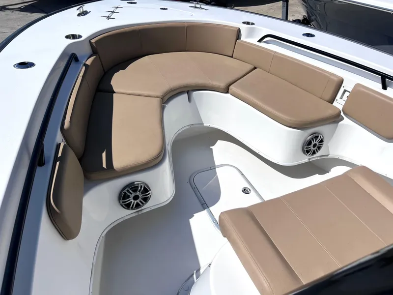Slide: The Image of 2022 Cape Horn 24 XS boat with tan cushioned seating and built-in speakers. - 17