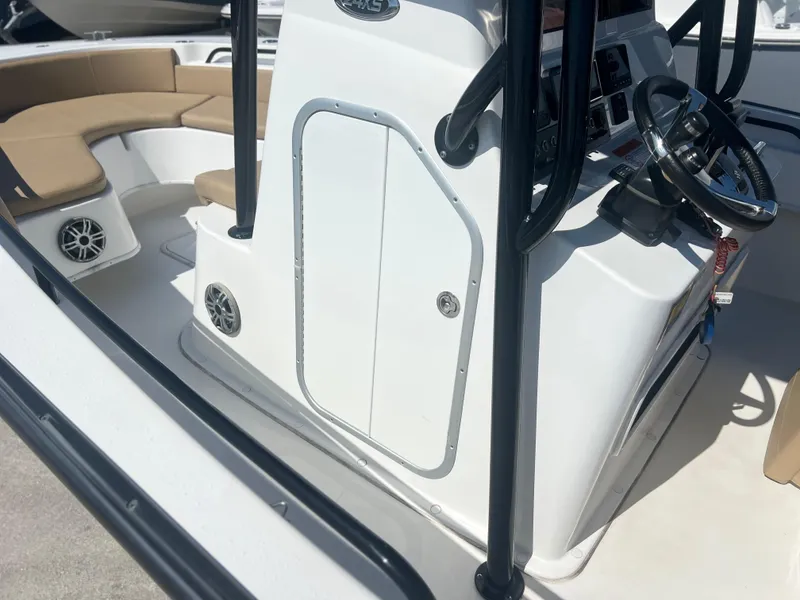 Slide: The Image of 2022 Cape Horn 24 XS boat interior with steering console and seating area. - 25