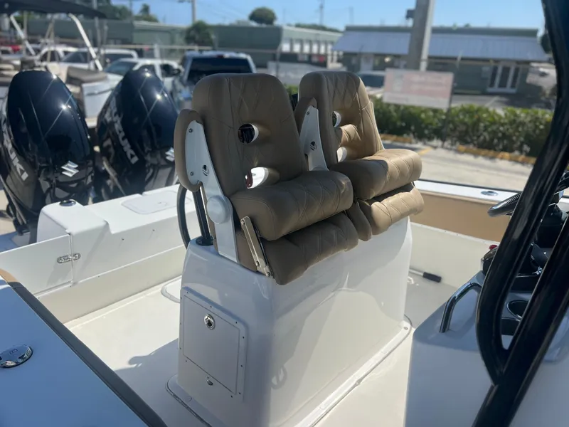 Slide: The Image of 2022 Cape Horn 24 XS boat with dual cushioned seats and twin outboard motors. - 30