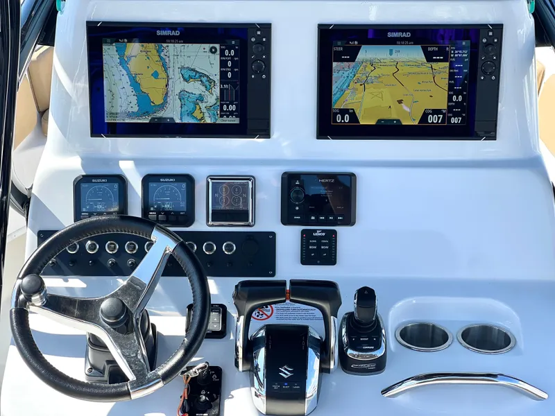 Slide: The Image of 2022 Cape Horn 24 XS boat dashboard with dual Simrad displays and navigation controls. - 35