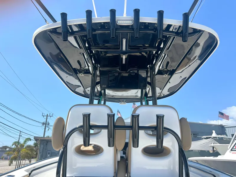 Slide: The Image of 2022 Cape Horn 24 XS boat with dual seats and rod holders, viewed from the rear. - 49