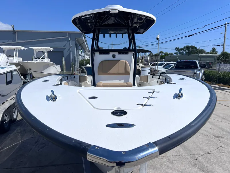 Slide: The Image of 2022 Cape Horn 24 XS boat with sleek design, docked outdoors. - 11