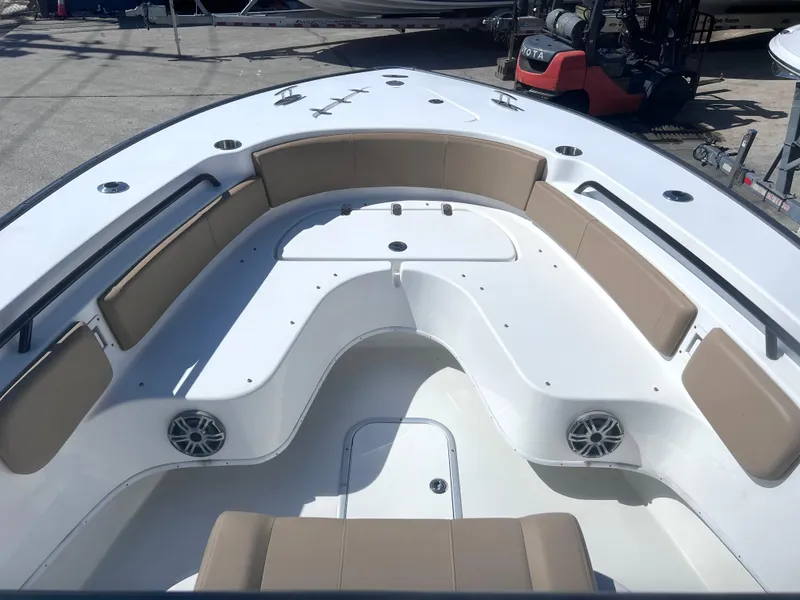 Slide: The Image of 2022 Cape Horn 24 XS boat interior with tan seating and speakers. - 15