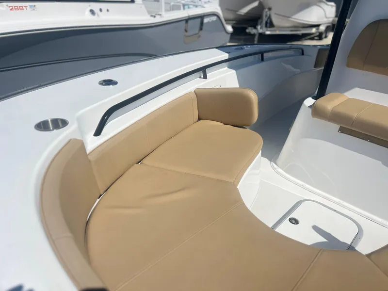 Slide: The Image of 2022 Cape Horn 24 XS boat with tan cushioned seating and sleek white interior. - 19