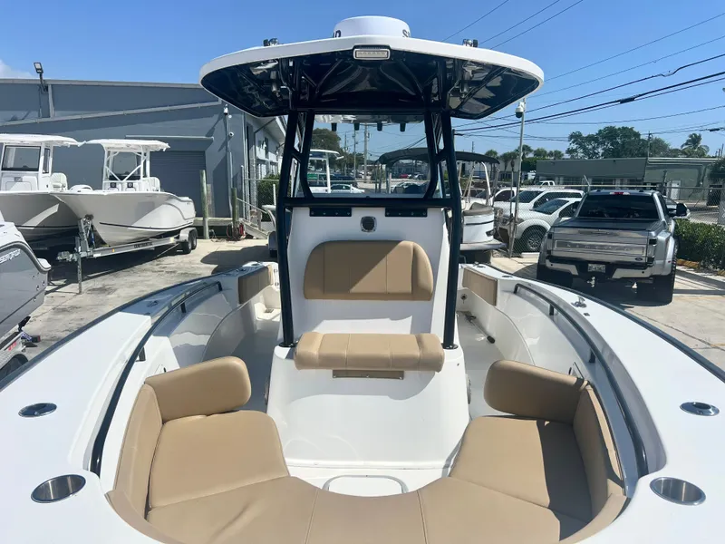 Slide: The Image of 2022 Cape Horn 24 XS boat with tan seating, docked outdoors. - 20