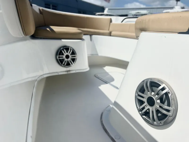 Slide: The Image of 2022 Cape Horn 24 XS boat interior with speakers and cushioned seating. - 23
