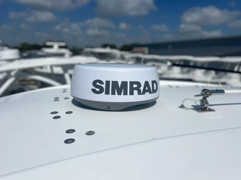 Slide: The Image of Simrad radar on 2022 Cape Horn 24 XS boat under a clear blue sky. - 24
