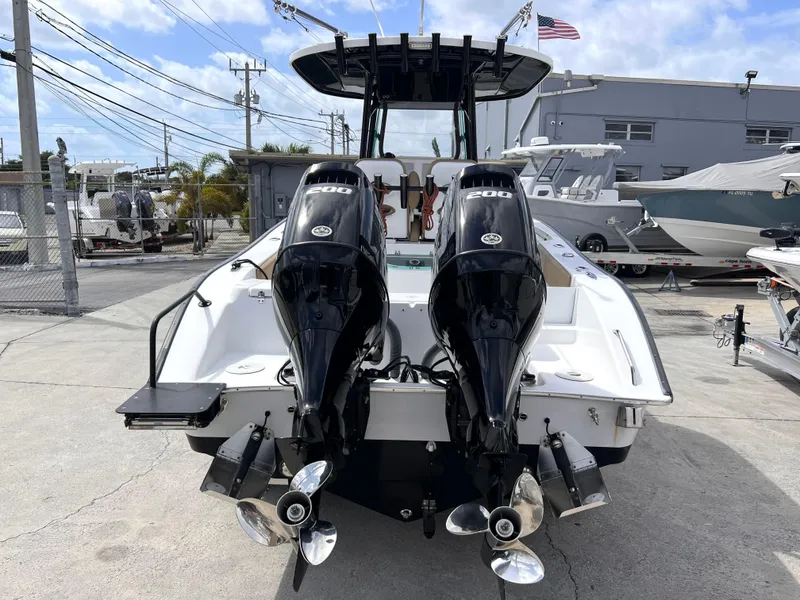 Slide: The Image of 2022 Cape Horn 24 XS boat with dual outboard engines, docked in a marina. - 3