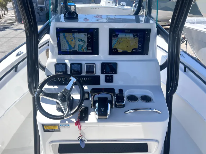 Slide: The Image of 2022 Cape Horn 24 XS boat dashboard with dual navigation screens and controls. - 33