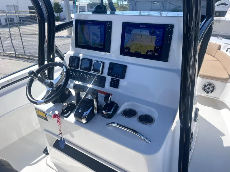 Slide: The Image of 2022 Cape Horn 24 XS boat console with dual navigation screens and controls. - 34