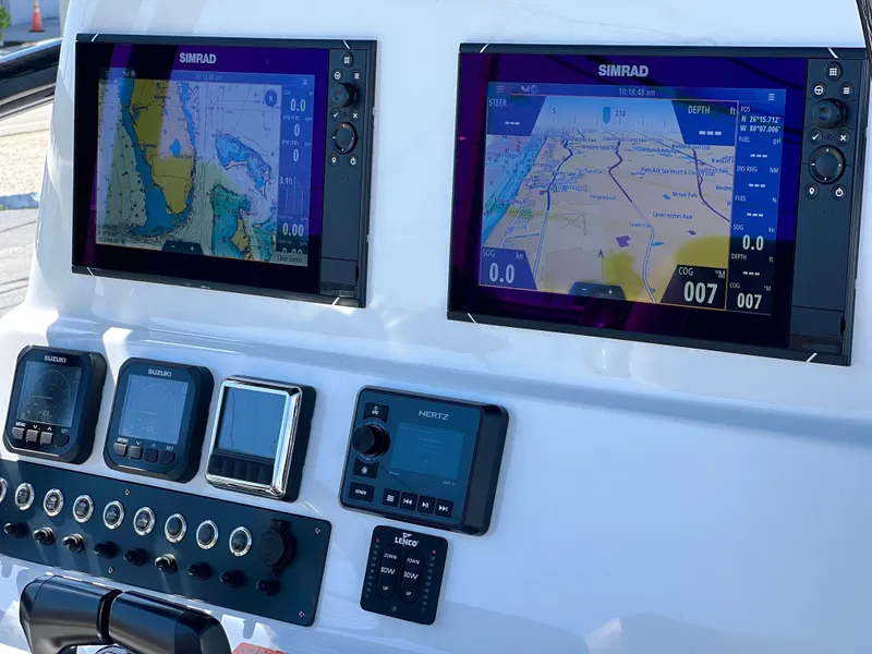 Slide: The Image of 2022 Cape Horn 24 XS boat dashboard with dual Simrad navigation displays. - 37
