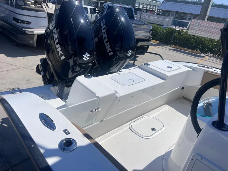 Slide: The Image of 2022 Cape Horn 24 XS boat with dual Suzuki outboard engines, docked in a marina. - 41