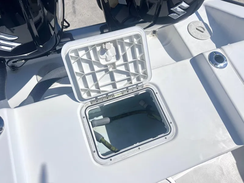 Slide: The Image of Open hatch on 2022 Cape Horn 24 XS boat deck, revealing storage compartment. - 42