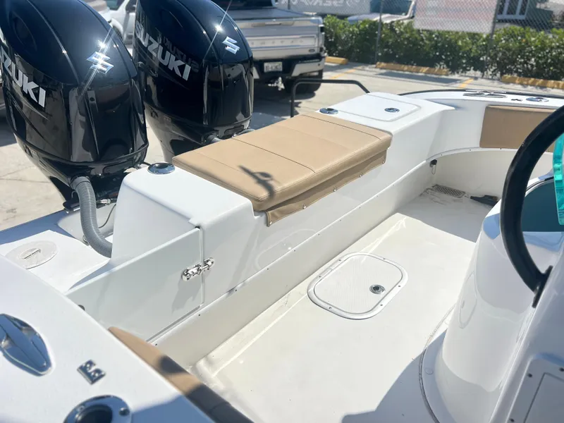 Slide: The Image of 2022 Cape Horn 24 XS boat interior with Suzuki engines, featuring a beige cushioned seat. - 44