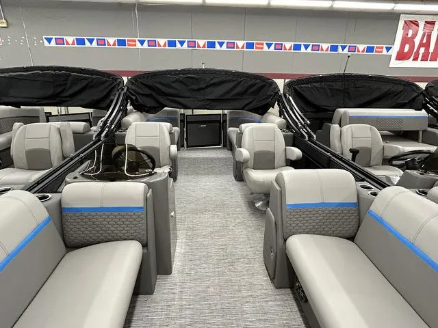Slide: The Image of 2023 Qwest 822 RLS pontoon boat interior with gray seating and blue accents. - 5
