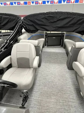 Slide: The Image of 2023 Qwest 822 RLS boat interior with gray seating and covered canopy. - 8