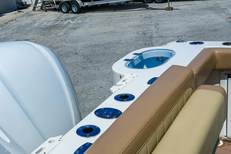 Slide: The Image of 2019 Sailfish 245 DC boat interior with seating and cup holders. - 13