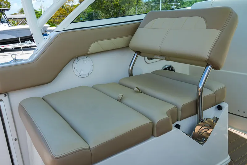 Slide: The Image of 2019 Sailfish 245 DC boat interior with beige cushioned seating. - 17