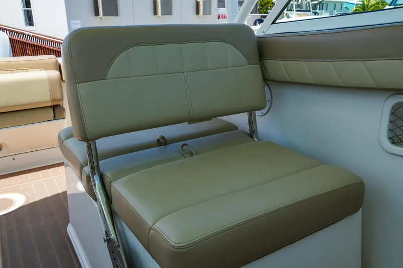 Slide: The Image of 2019 Sailfish 245 DC boat interior with beige seating and modern design. - 18