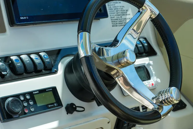 Slide: The Image of Steering wheel and controls of 2019 Sailfish 245 DC boat cockpit. - 21