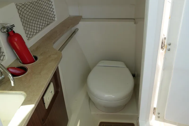 Slide: The Image of Compact bathroom in 2019 Sailfish 245 DC boat with toilet and sink. - 27