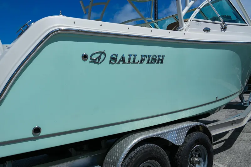 Slide: The Image of 2019 Sailfish 245 DC boat on trailer, side view with logo. - 3