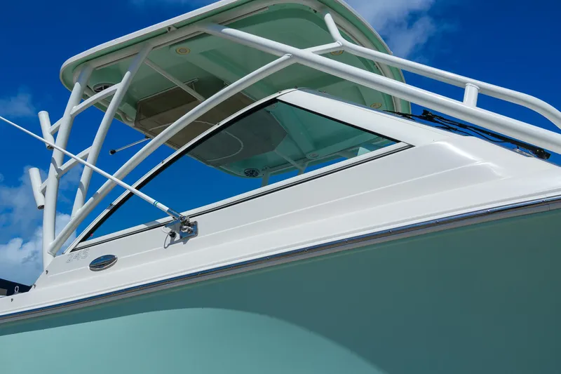 Slide: The Image of 2019 Sailfish 245 DC boat with sleek design against a clear blue sky. - 4
