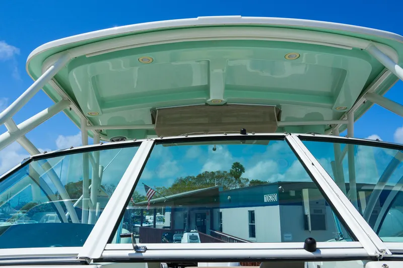 Slide: The Image of 2019 Sailfish 245 DC boat windshield and hardtop against a clear blue sky. - 8