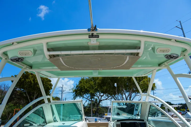 Slide: The Image of 2019 Sailfish 245 DC boat with canopy and clear blue sky background. - 9