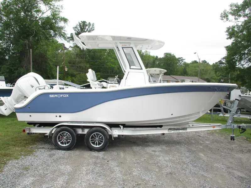 Slide: The Image of 2025 Sea Fox 228 Commander boat on trailer, parked outdoors. - 3