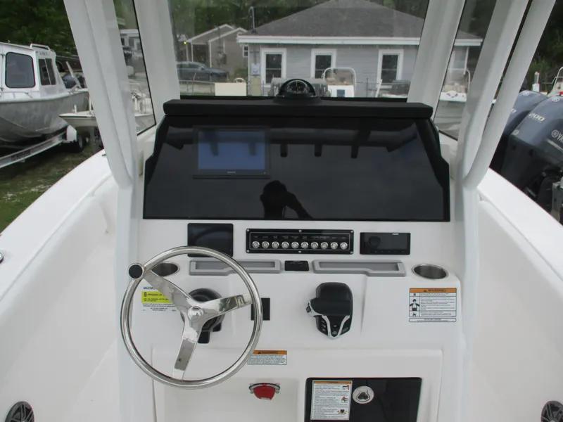 Slide: The Image of 2025 Sea Fox 228 Commander boat dashboard with steering wheel and control panel. - 6