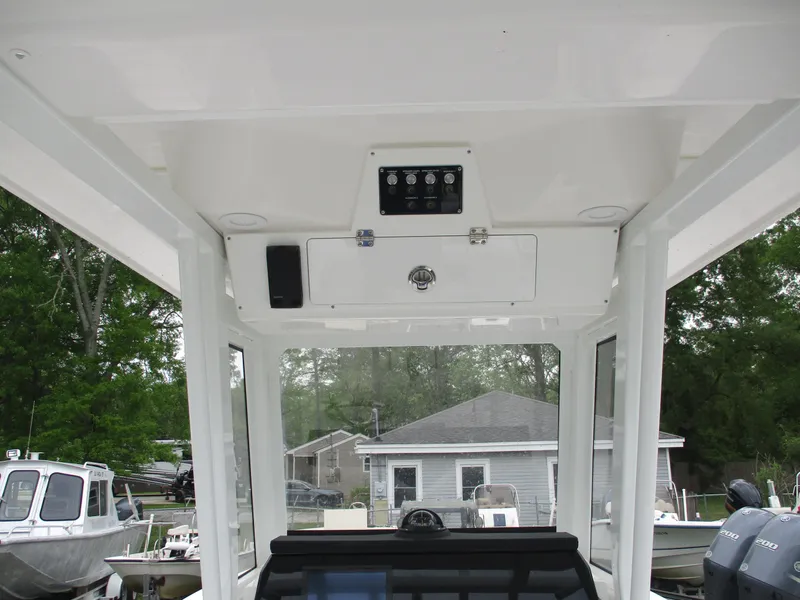 Slide: The Image of 2025 Sea Fox 228 Commander boat interior, featuring control panel and overhead storage. - 7
