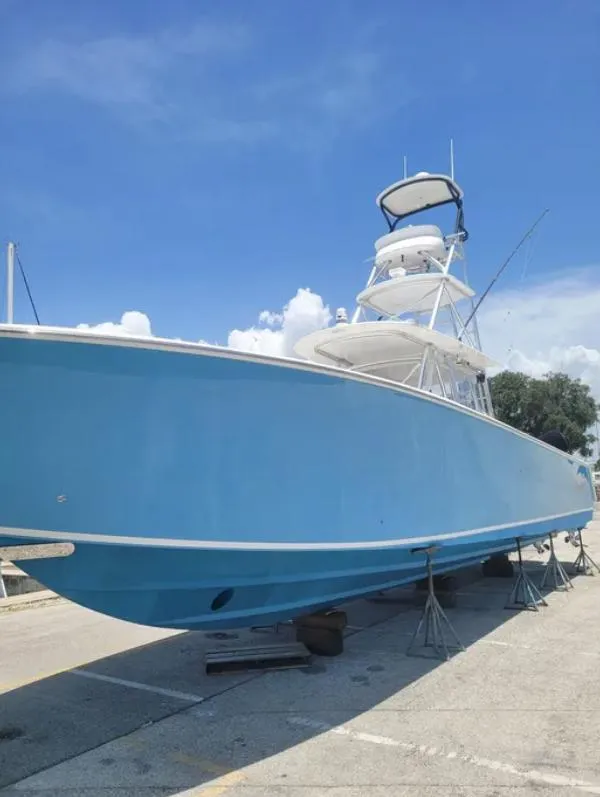Slide: The Image of 2014 SeaHunter Tournament boat on dry dock under clear blue sky. - 1