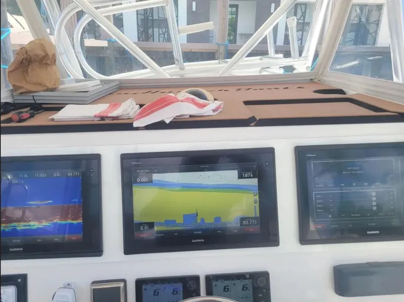 Slide: The Image of Control panel of a 2014 SeaHunter Tournament boat with navigation screens and equipment. - 4