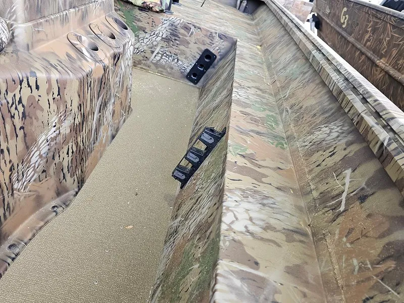 Slide: The Image of 2025 G3 Gator Tough 17 CC boat interior with camouflage design and seating area. - 11