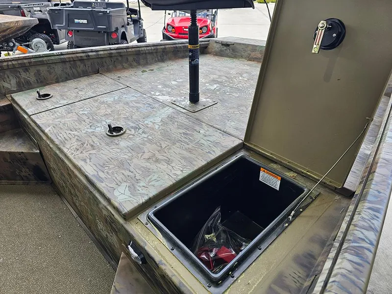 Slide: The Image of 2025 G3 Gator Tough 17 CC boat interior with open storage compartment and camouflage design. - 14