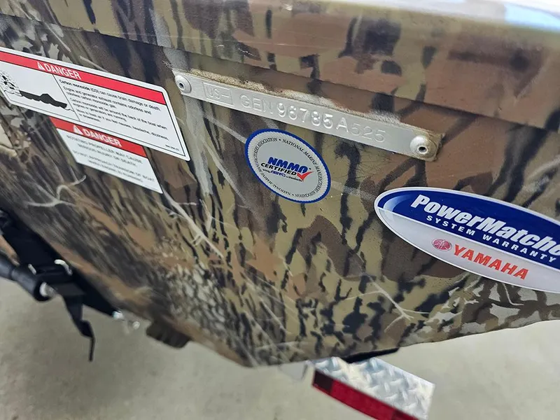 Slide: The Image of 2025 G3 Gator Tough 17 CC boat with camouflage design and warranty stickers. - 17