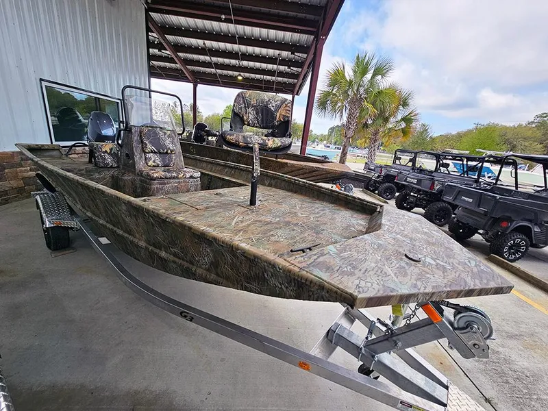 Slide: The Image of 2025 G3 Gator Tough 17 CC boat with camouflage design on a trailer. - 2