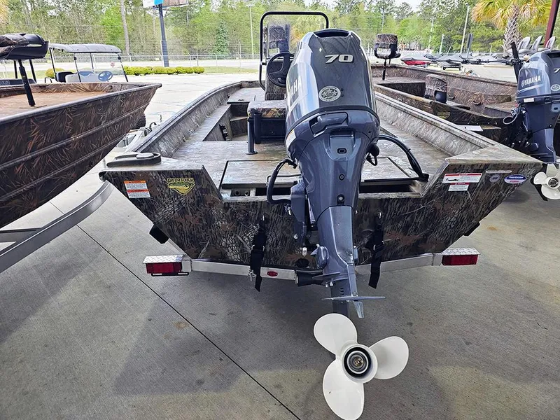 Slide: The Image of 2025 G3 Gator Tough 17 CC boat with 70 HP motor, parked outdoors. - 6
