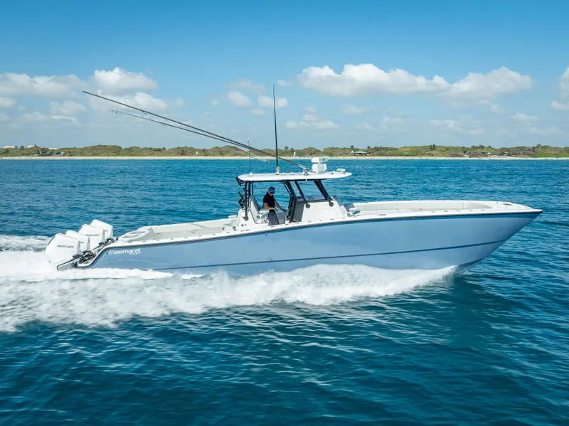 Slide: The Image of 2019 Freeman 42 LR boat cruising on blue ocean under clear sky. - 11