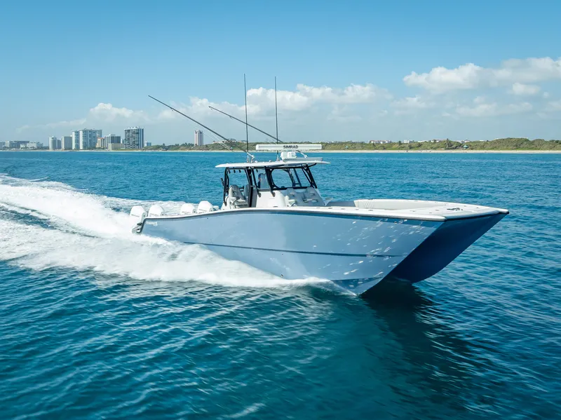Slide: The Image of 2019 Freeman 42 LR boat cruising on blue ocean near city skyline. - 12