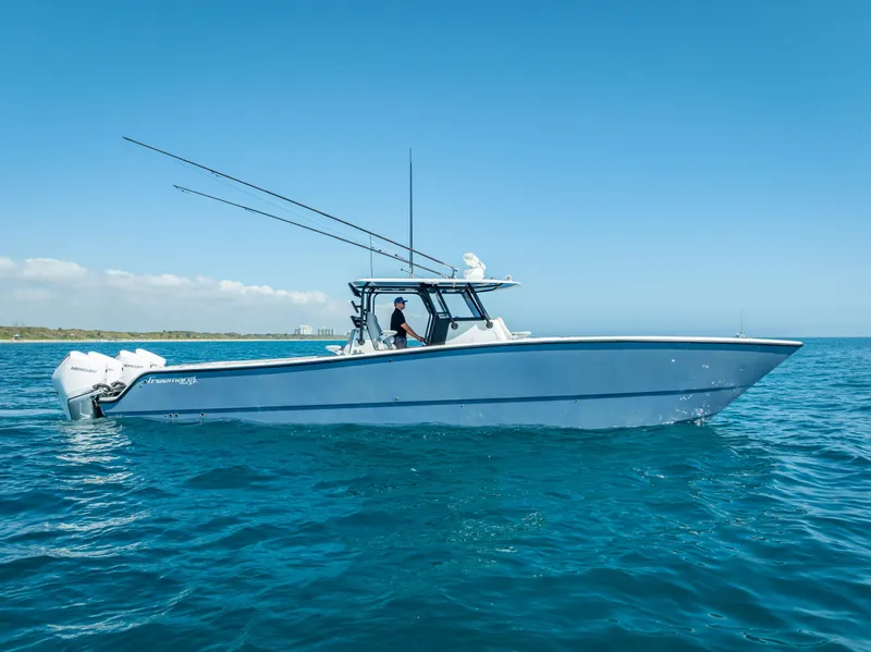 Slide: The Image of 2019 Freeman 42 LR boat cruising on clear blue ocean waters. - 13