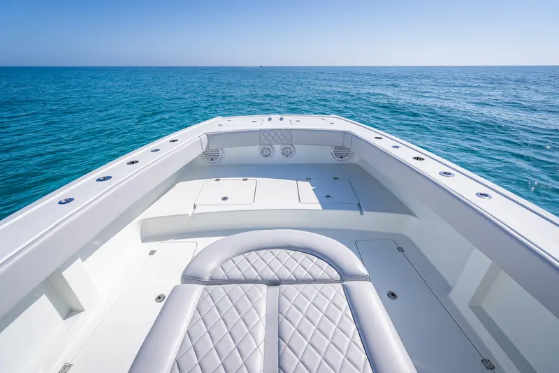 Slide: The Image of 2019 Freeman 42 LR boat on open sea, showcasing spacious deck and luxurious seating. - 15