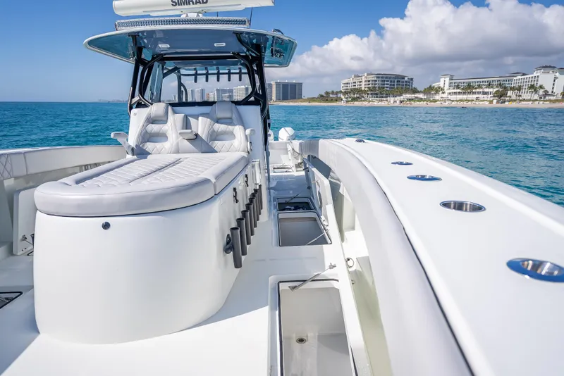 Slide: The Image of 2019 Freeman 42 LR boat on ocean, luxury seating, coastal buildings in background. - 18