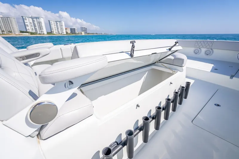 Slide: The Image of 2019 Freeman 42 LR boat interior with rod holders, ocean view, and city skyline. - 19
