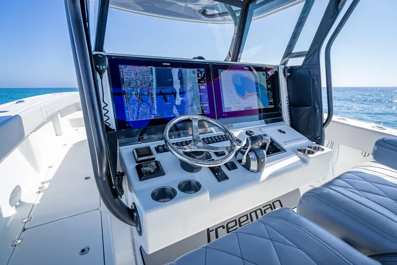 Slide: The Image of 2019 Freeman 42 LR boat cockpit with advanced navigation system and ocean view. - 21