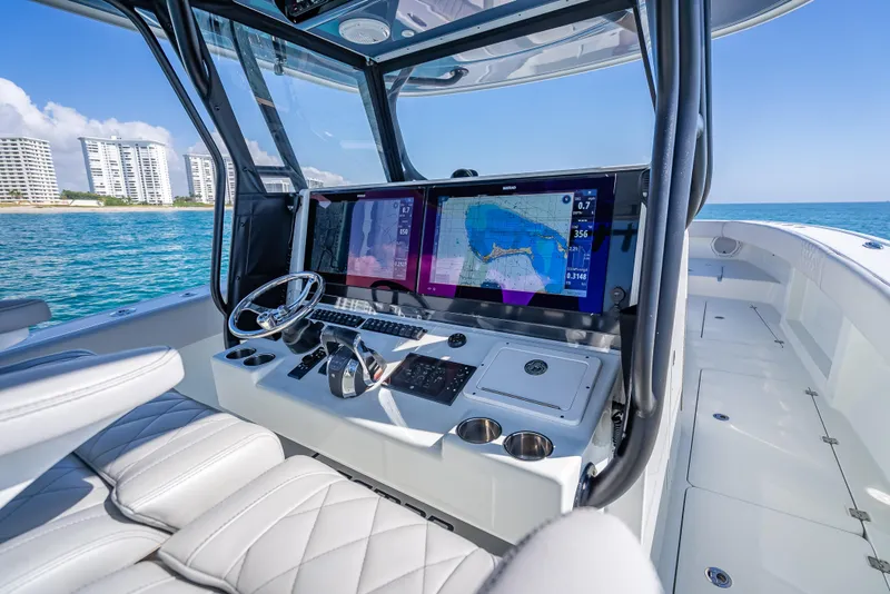 Slide: The Image of 2019 Freeman 42 LR boat cockpit with modern navigation system, steering wheel, and ocean view. - 22