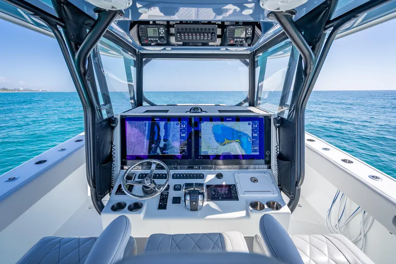 Slide: The Image of Cockpit of 2019 Freeman 42 LR boat with advanced navigation screens and steering wheel. - 23